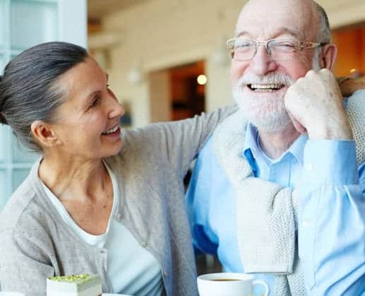 middle aged couple drinking coffee and smiling
